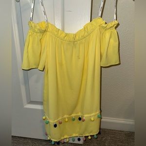 Off shoulder yellow top with pom poms
